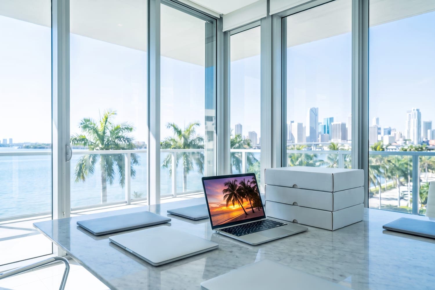 Office overlooking Biscayne Bay in Miami with laptops for a business order